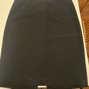 Black pencil skirt, slit in back, side zip, detail around waist